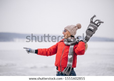 Woman in winter outside by the lake
