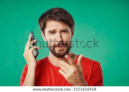 A bearded man holds a smartphone in his hands a conversation providing a service description
