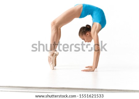 woman in blue swimsuit ballerina pointe exercises gymnastics