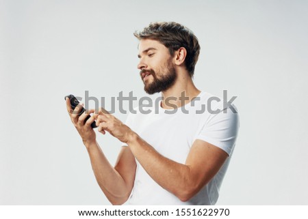 Mobile phone sensor young man white t-shirt