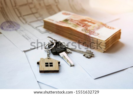 bundle of five thousand notes with keys to an apartment or house on a white background. Buying real estate for Russian money.