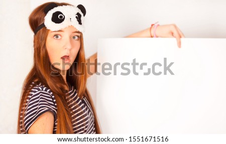teen girl leaning on big blank board