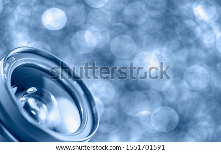 Camera lens glass with blue bokeh 