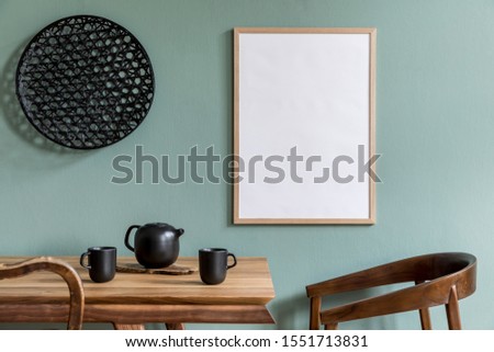 Stylish scandinavian dining room interior with mock up poster frame, wooden table, furniture, teapot with cups, black decoration and elegant accessories. Ready to use. Template. Modern home decor.