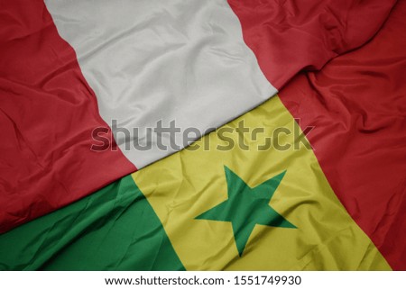 waving colorful flag of senegal and national flag of peru. macro
