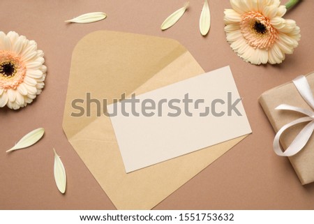 Flat lay composition with greeting card on brown background, space for text. Happy Mother's Day