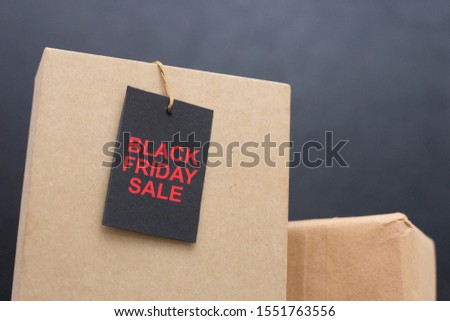 Boxes with a black stamp that has inscription BLACK FRIDAY SALE. Holidays promotional offers concept. Discount symbol represented by a stamp in front of the boxes.