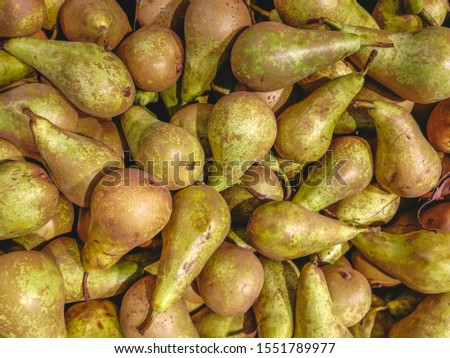 Green pear texture: lots of green pears. pears storage. Bunch of green delicious pears in a box in supermarket
