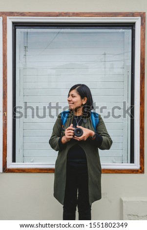 Female photographer holding camera with hands
