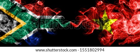 South Africa vs Vietnam, Vietnamese smoky mystic flags placed side by side. Thick colored silky abstract smoke flags concept