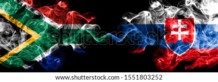 South Africa vs Slovakia, Slovakian smoky mystic flags placed side by side. Thick colored silky abstract smoke flags concept
