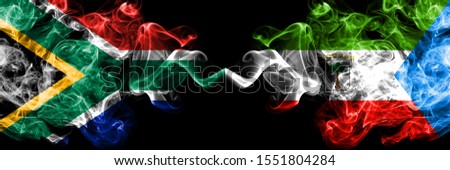 South Africa vs Equatorial Guinea smoky mystic flags placed side by side. Thick colored silky abstract smoke flags concept