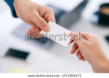 Two businessman holding and giving empty business card 