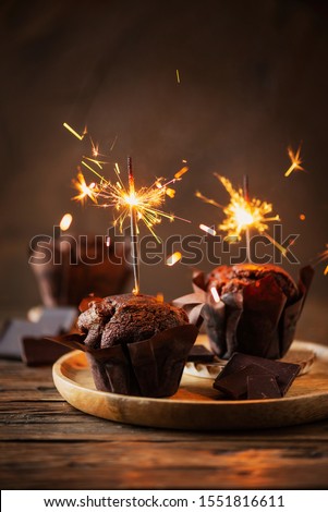 Sweet muffins with choccolate and sparkler, selective focus image