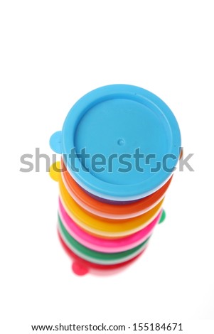Colored finger paints for children/Bright colored cans of paint on a white background