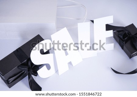 Black Friday Sale text on gray background and black with a white bag gifts. Black Friday sale, fall, promotion advertising
