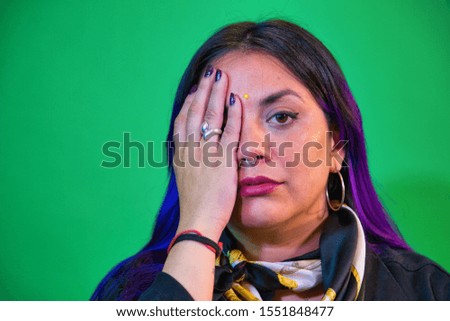 portrait of latin woman blue and purple painted hair with background view