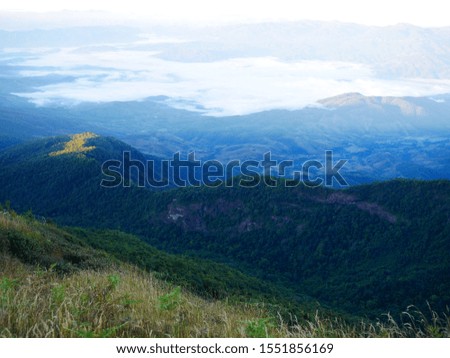 Peaceful mountain background, green grasses and blue skies