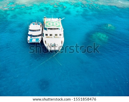 Great Barrier Reef, Queensland / Australia / 09 21 2018: Tour boats floating together on the water at Norman Reef, GBR, Australia