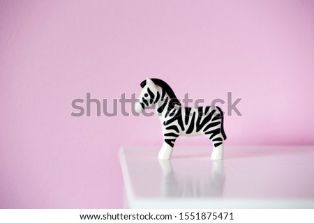 Close up of Toy of zebra against pink background 