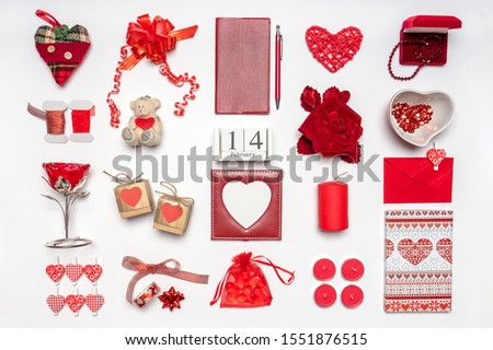 Stylish accessories, decorative items and miniature toys in red color on white background. Calendar date February 14, greeting card for Valentine's day. Love and romance concept. Copy space, mock up