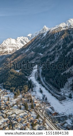 Aerial drone view of Chamonix city at the foot of snow covered Alps mountain brevent