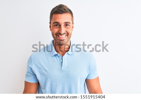 Young handsome elegant man wearing blue t-shirt over isolated background with a happy and cool smile on face. Lucky person.