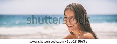 Happy smiling youn Asian woman relaxing on ocean beach summer background. Vacation travel banner panoramic people lifestyle.
