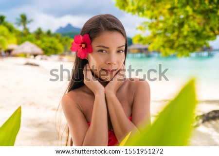 Spa Asian natural beauty woman wellness skin care touching face looking at camera serene outside. Beautiful skincare concept with mixed race model girl.