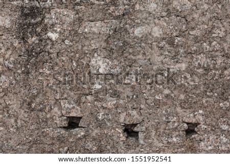 Age grunge house stone boulder background. Solid uneven mosaic surface stacked wall. Medieval Europe mansion yard. Dirty rural farm rock texture. Fortified district vintage estate facing castle for 3d