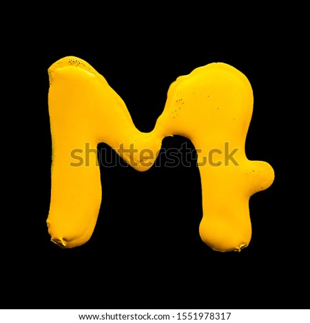 Latin alphabet. letter M  of yellow gouache.
