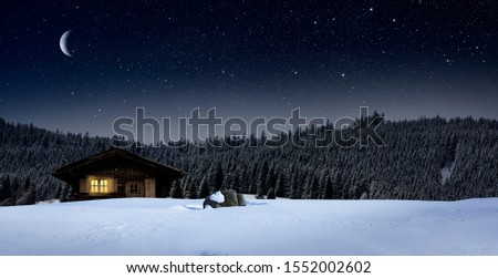 cozy cottage in wintertime at night