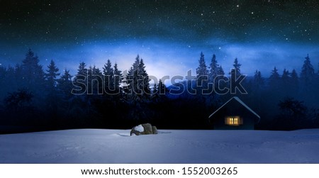 cozy blockhouse in wintertime at night