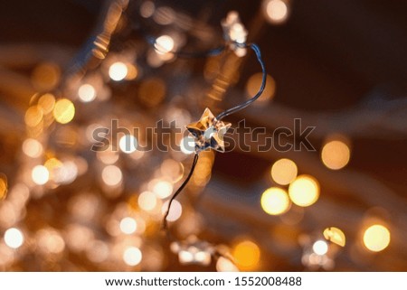 Glittering golden Christmas star and blured lights on the background