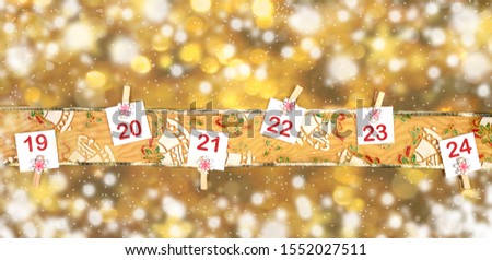 19-23 part of Advent calendar on festive ornamented Golden ribbon on background of blurred golden bokeh with snow.