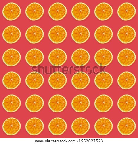 Seamless pattern of handmade dried orange slices on trendy pink background. Creative diy christmas decorations flat lay background. Square photo.
