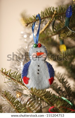 handmade snowman decoration on Christmas tree