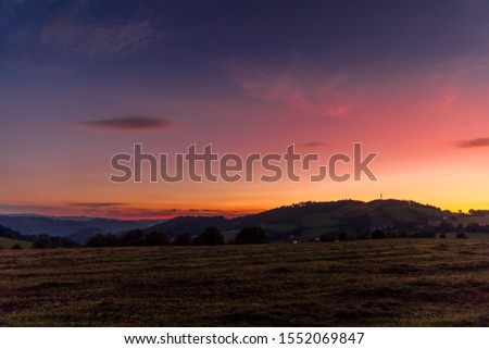 Multi colored sky of hill Velka Lhota Beskydy area sky and clouds play with many colors with view to surround the nature area around many small hills and mountains around capturing during sunset.
