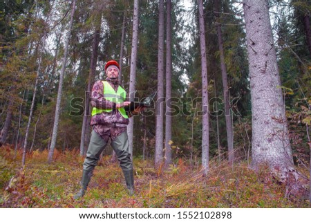 Forest engineer works in the forest on a computer. Forestry and forest monitoring. Voluntary forest certification.