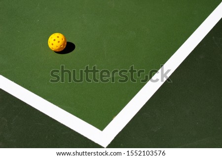  Pickleball and pickle ball court Royalty-Free Stock Photo #1552103576