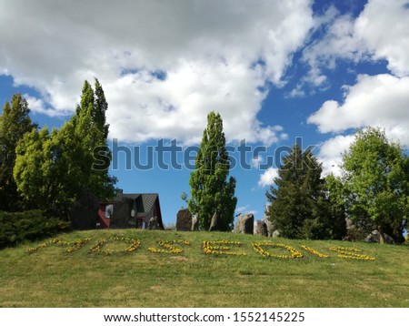 Mosedis village of stones, blue sky white clouds and grass. Lithuania nature in spring month