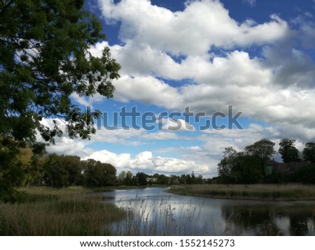 Mosedis village of stones, blue sky white clouds and grass. Lithuania nature in spring month