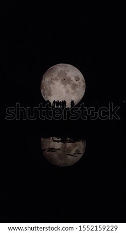 Night shot of the Miniature of the moon and the reflection on water.