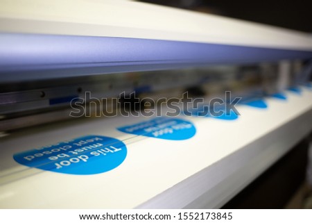 Wide-format inkjet printer in action  Royalty-Free Stock Photo #1552173845