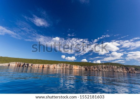View from the sea to the rocky shore