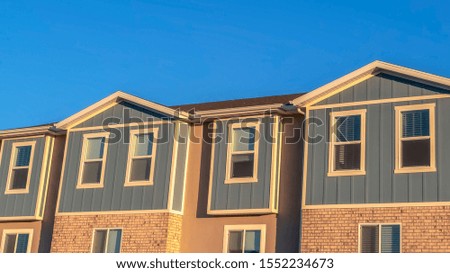 Panorama Focus on the upper storey of townhomes with blue sky background on a sunny day