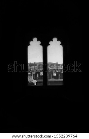Medieval window of a castle overlooking the countryside
