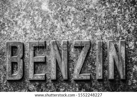 benzin - iron word made from metal letters. A gas station metal label