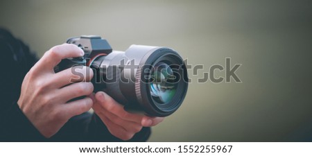 Man taking picture with photo camera, modern technology, close-up