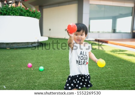 Cute kid or child playing colorful balls